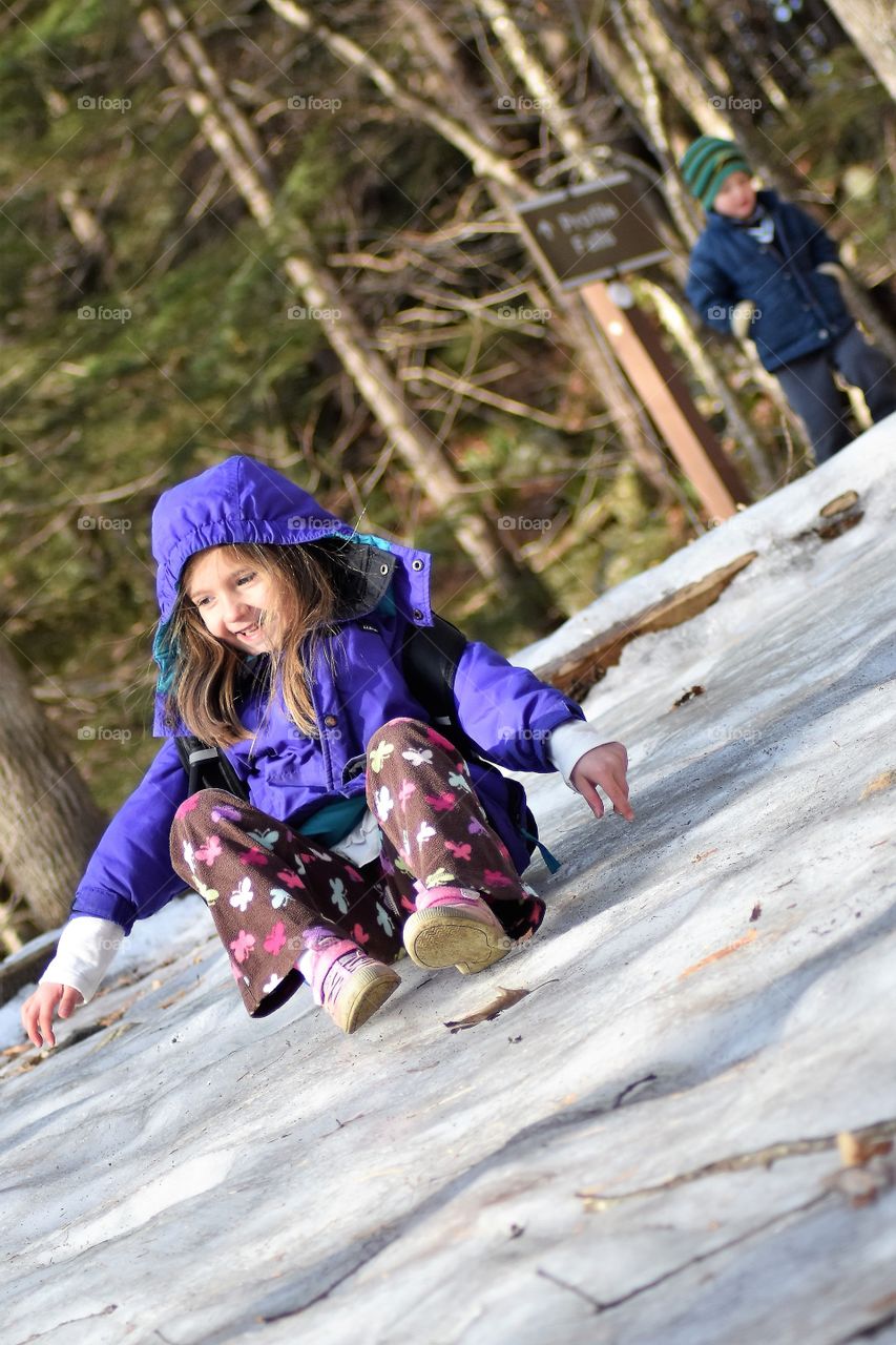 girl sliding on her behind