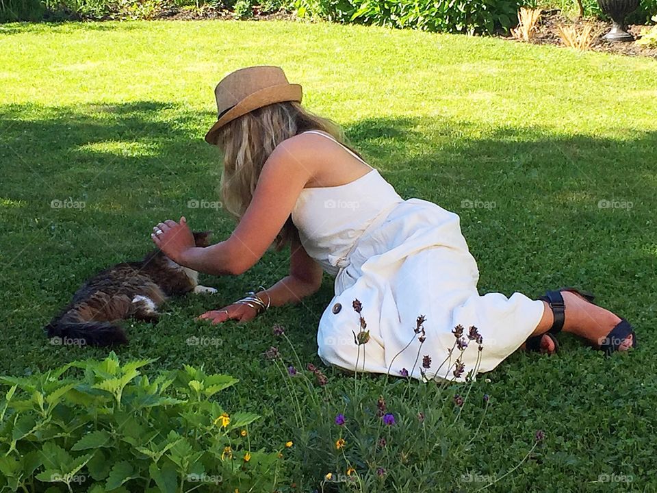 Special moments a girl and her cat in the grass 