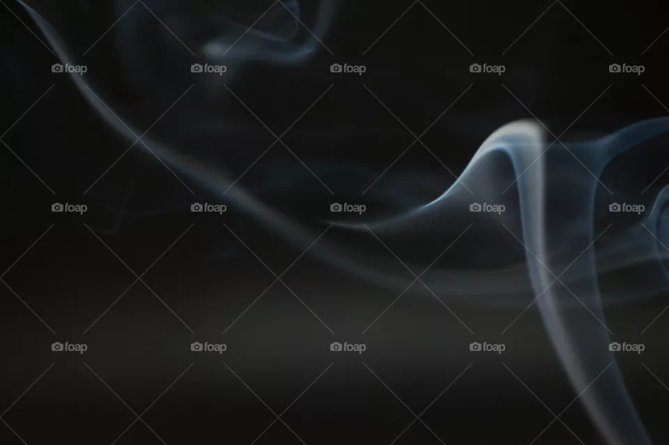 Smoke scented candles on a black background