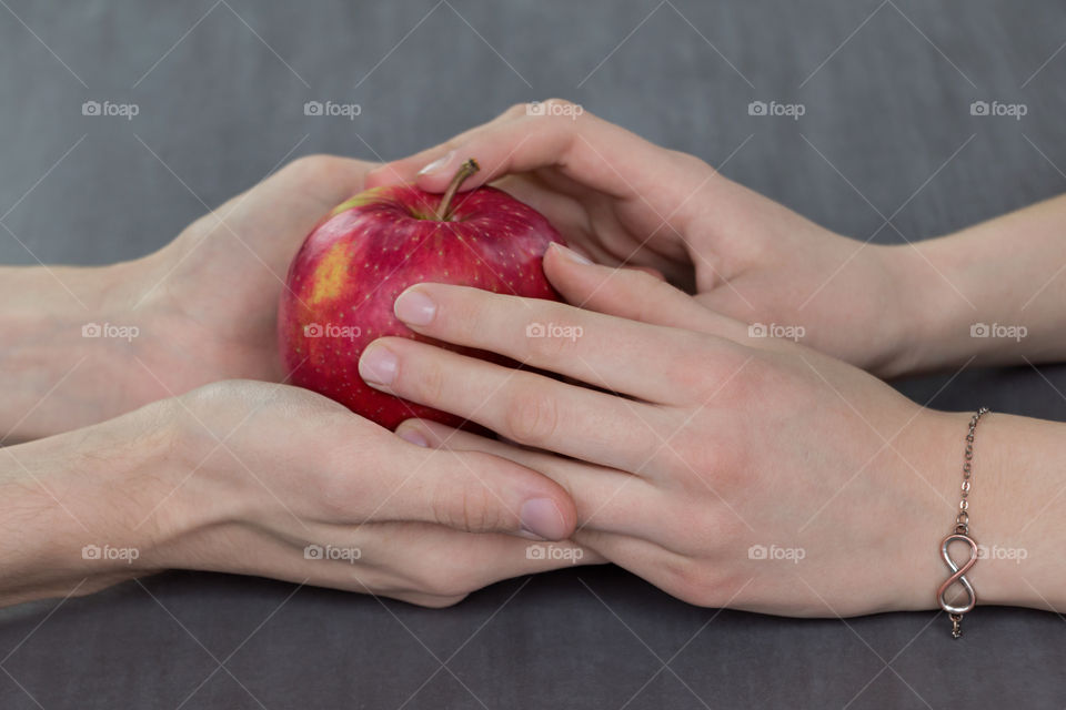 Close-up of holding hand with apple