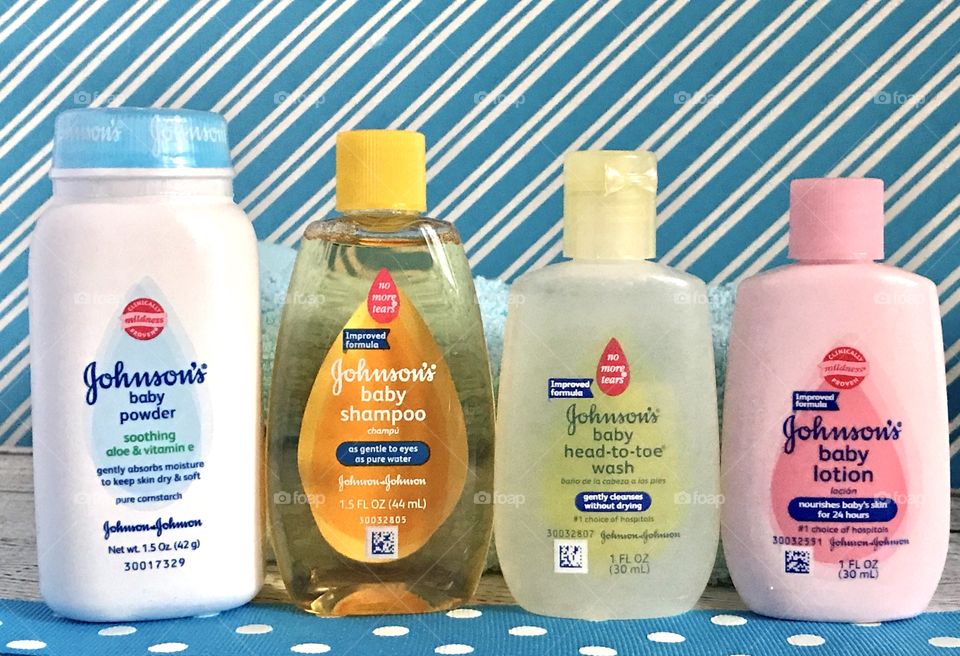 Johnson and Johnson baby lotion, shampoo, head to toe wash and powder on a blue and white background