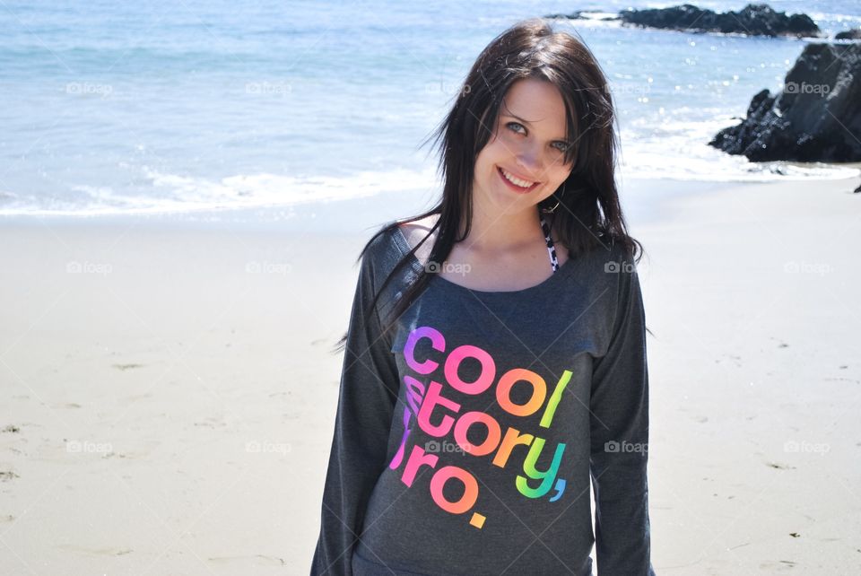 Teenage girl smiling at beach