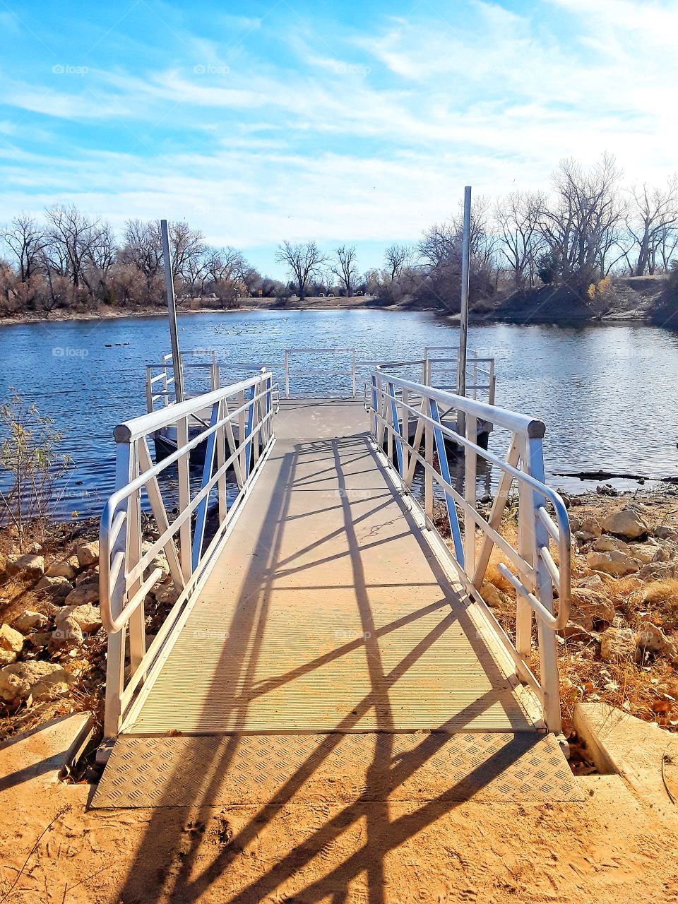 Walkway dock leading to park pond