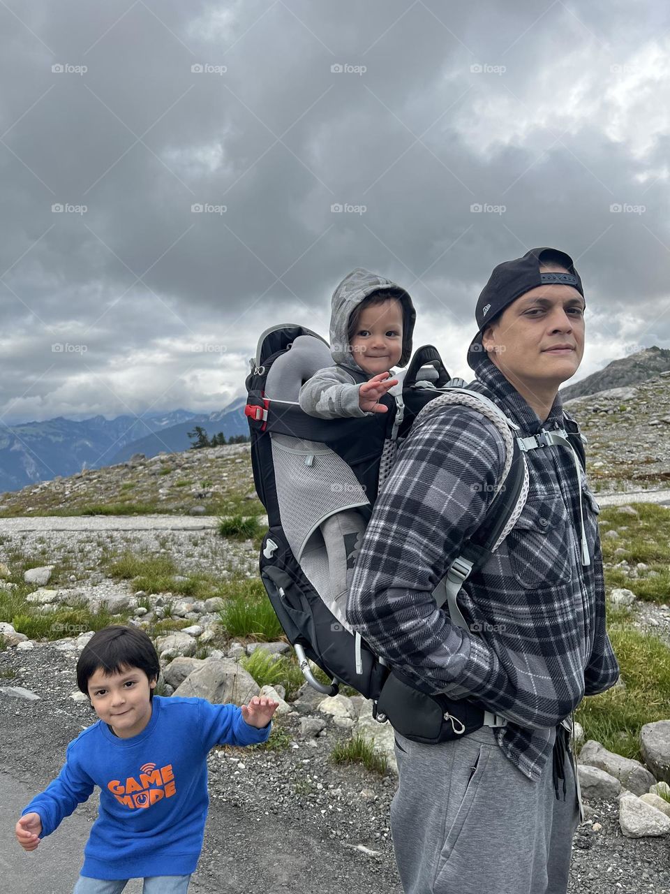A father on a hike with his two boys. 