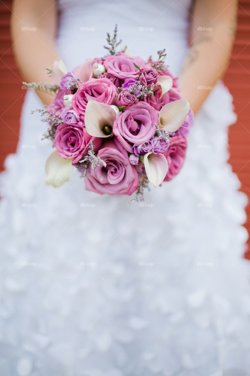 Bride in white dress holding flowers 
