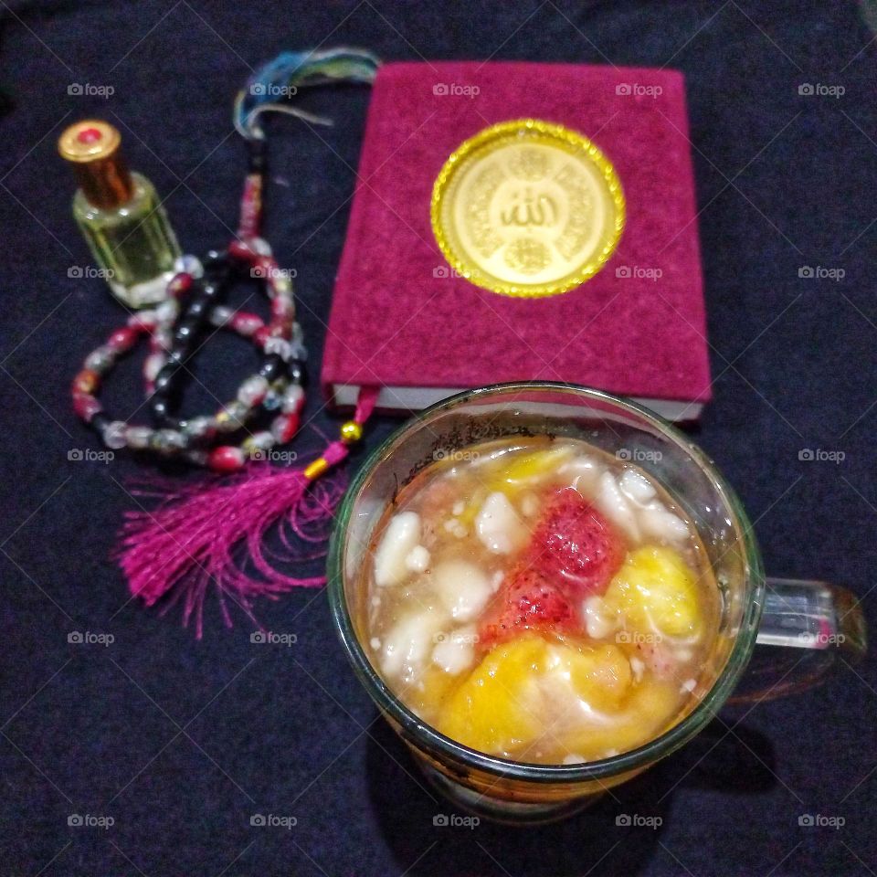A glass of fruit drink (dinghy) for starters and fragrant prayer beads and the Holy Bible