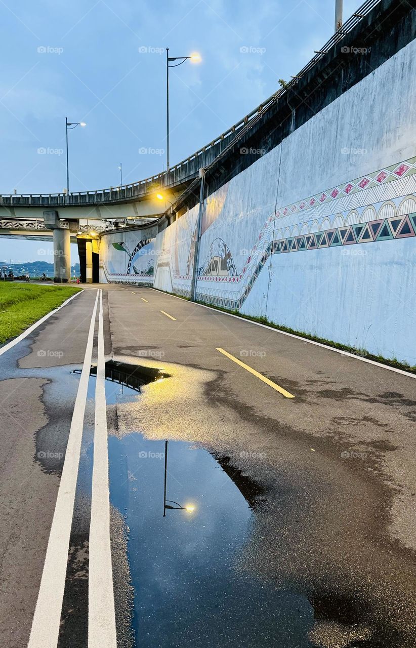 Streetlight reflected in puddle
