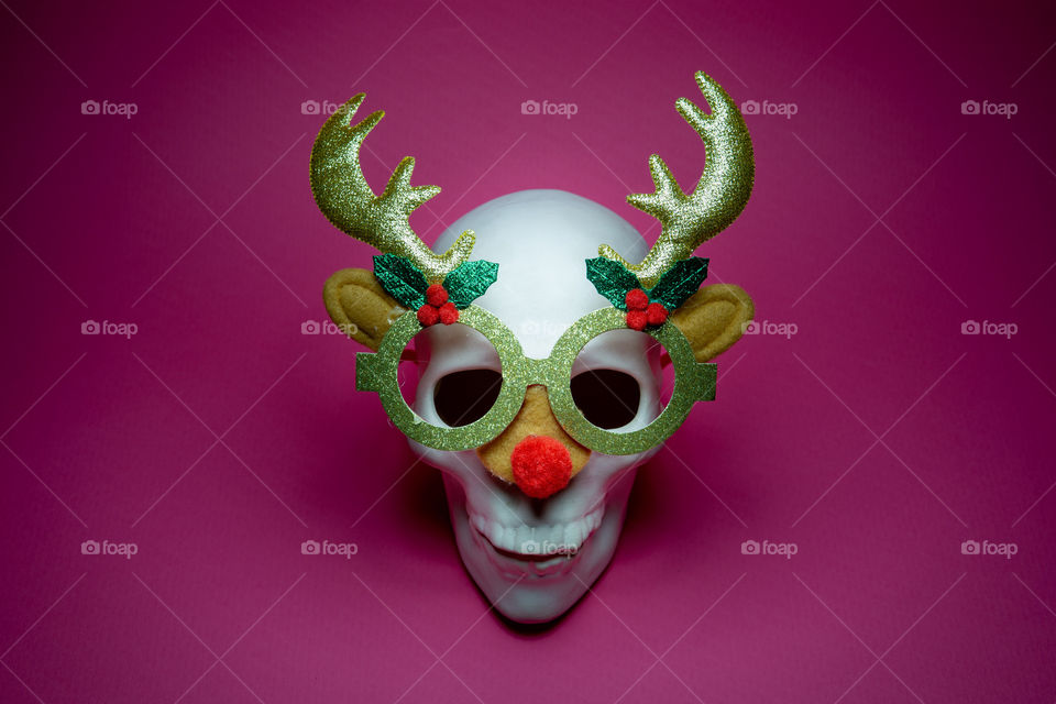 White skull with deer eyeglasses. Abstract Christmas background