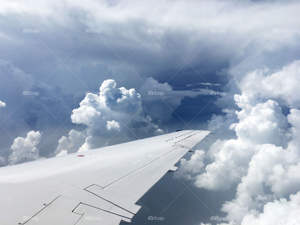 Airplane wing storm skies window view