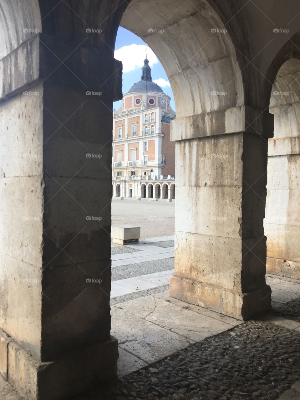 A sneak peak of the Royal Palace through the arches that are across of the Palace.  