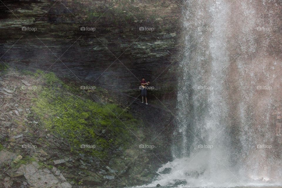 Playing under a waterfall