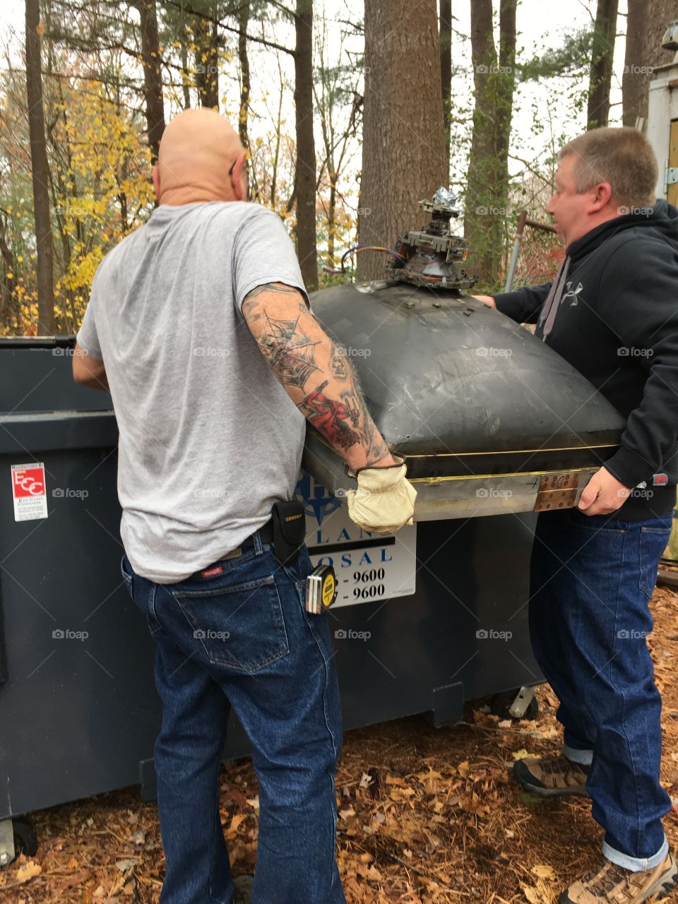 Lifting Old Heavy Picture Tube Into Dumpster!