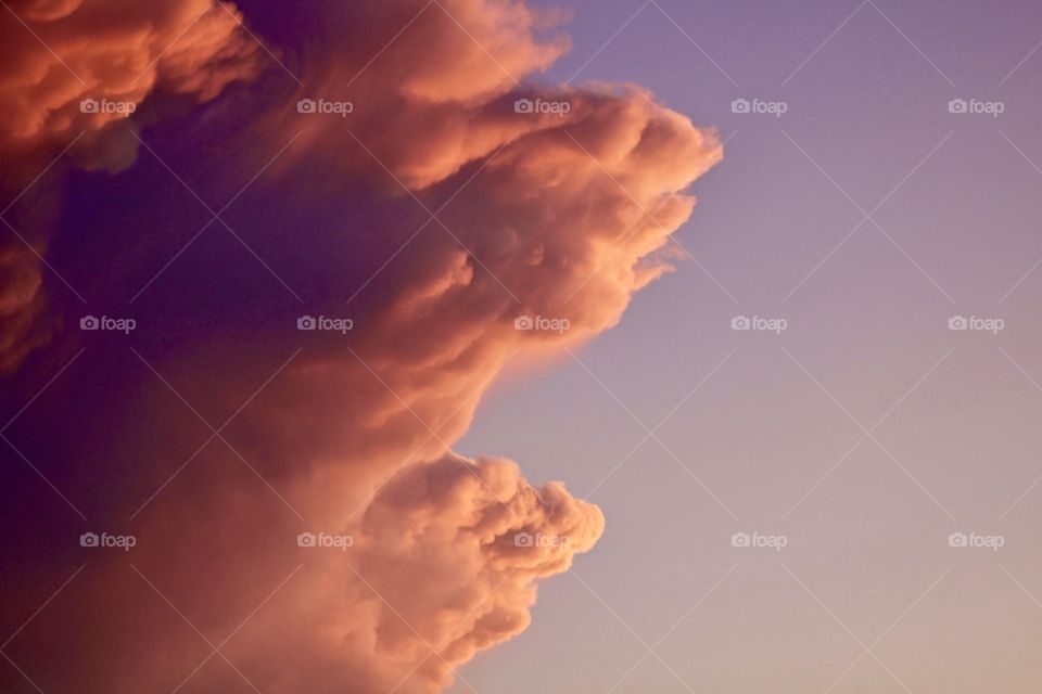 Isolated view of a colorful, dramatic tower of cumulonimbus clouds