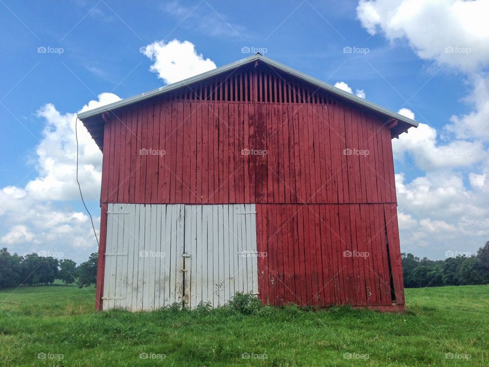 Red barn in a field. Red barn sky