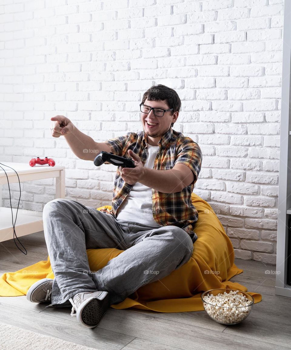 young emotional man playing video games