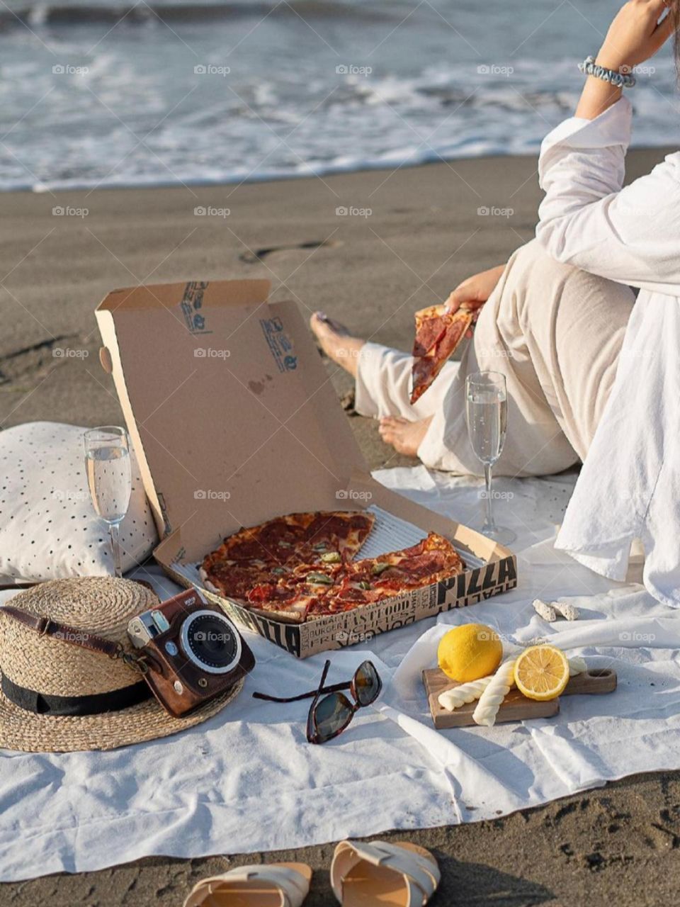 Eating pizza and taking photos at the beach, happiness is in a slice of pizza and salty sand