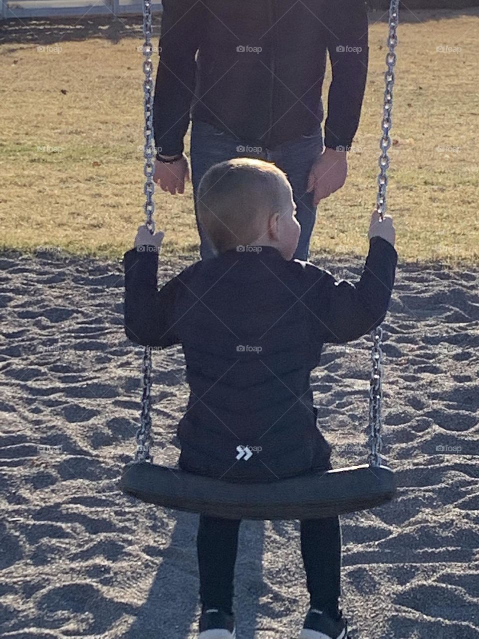 Little boy swings