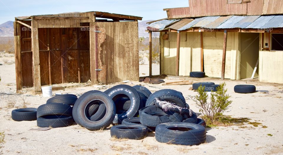 Abandoned tires in front of an abandoned house