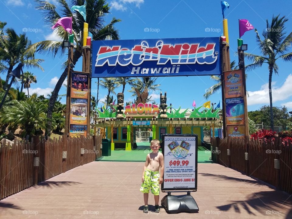 Bou stands at entrance to Wet n Wild Oahu