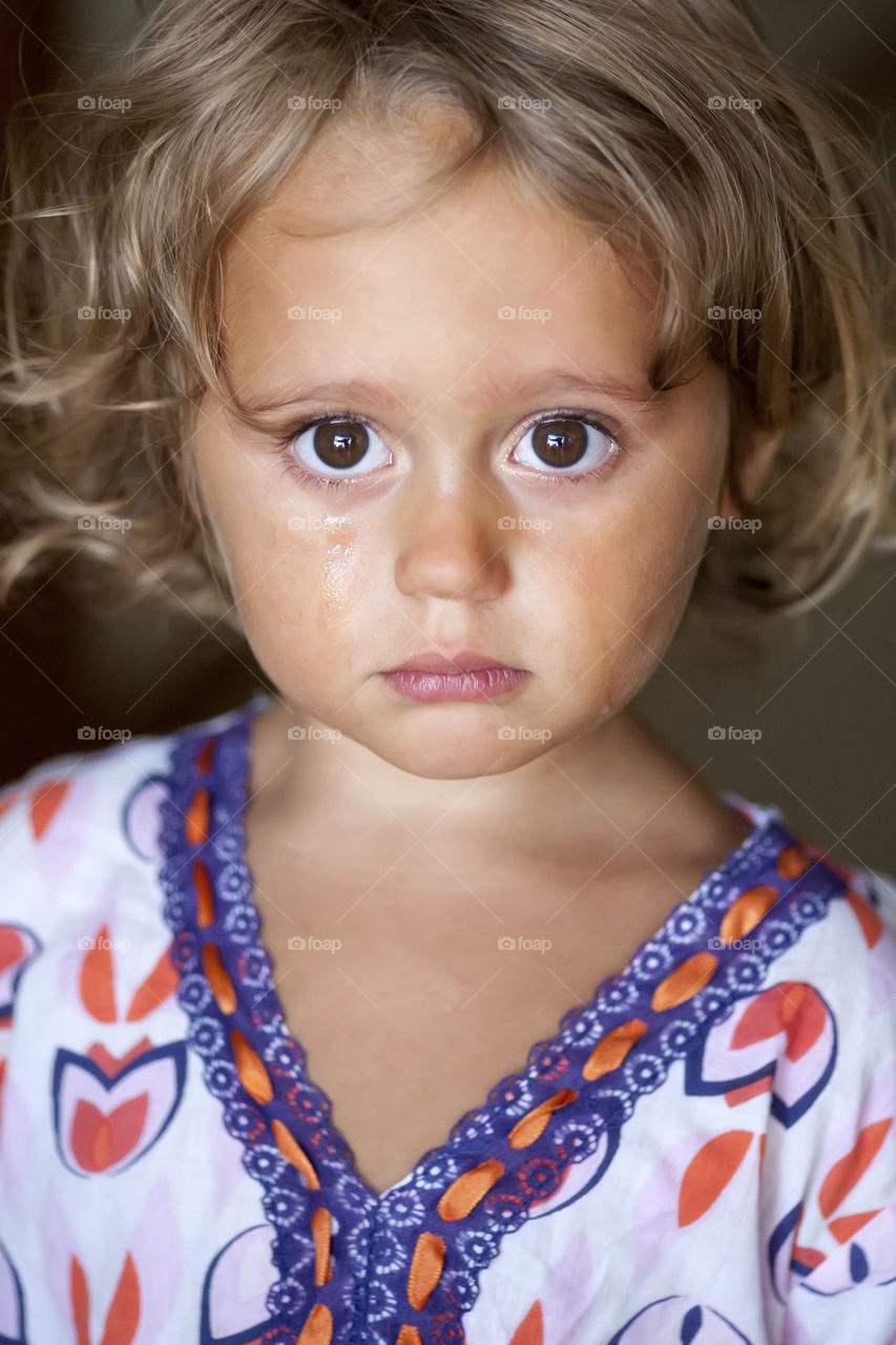 portrait of a crying girl with big expressive eyes