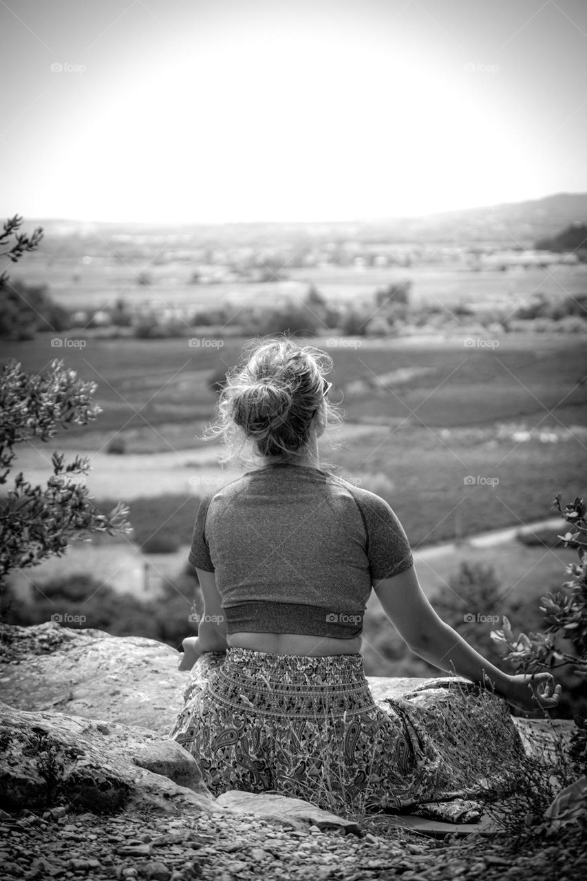 Young woman practicing yoga on mountain top