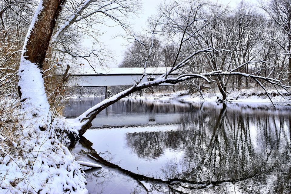 Beautiful winter day on the white river and the old covered bridge in Indiana with some old trees 