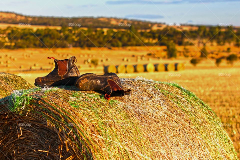 work boots on hay bale in rural Western Australia