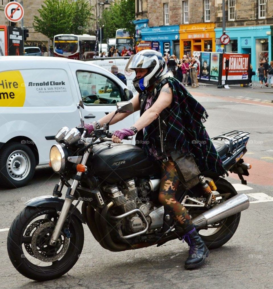 Motorbike rider wearing tartan seen in Edinburgh, Scotland during the Fringe Festival.