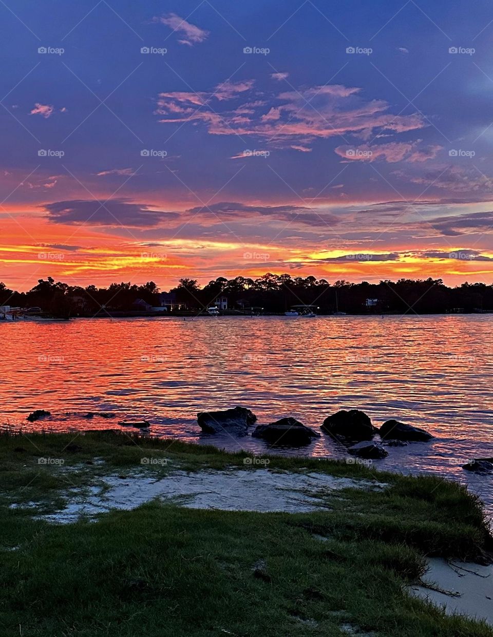 A breathtaking and radiant sunset colors the water and sky iridescent was glorious to behold and increasing every moment in splendor. 