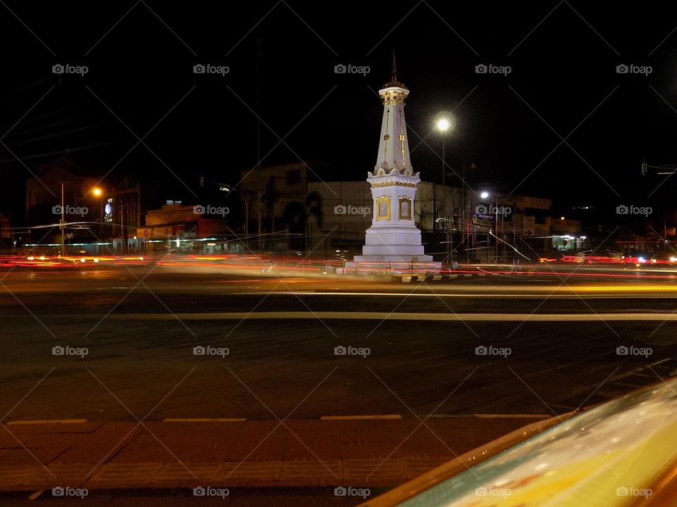 Historic monuments and the lights of motorbikes and cars at night in marvel colors