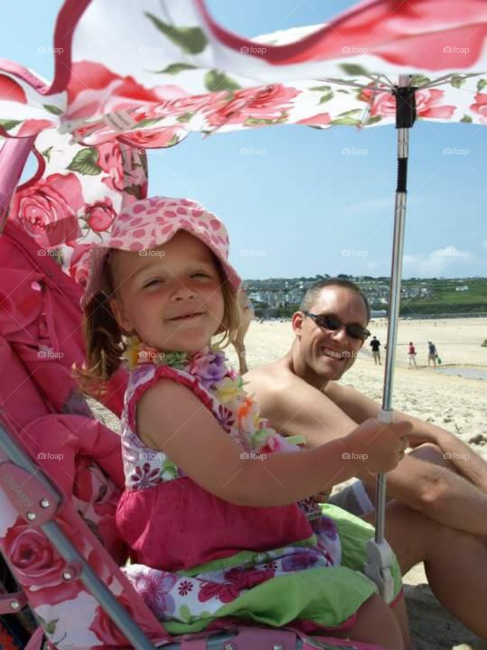 toddler daughter with her daddy on a beach in Cornwall.  st Ives bay
