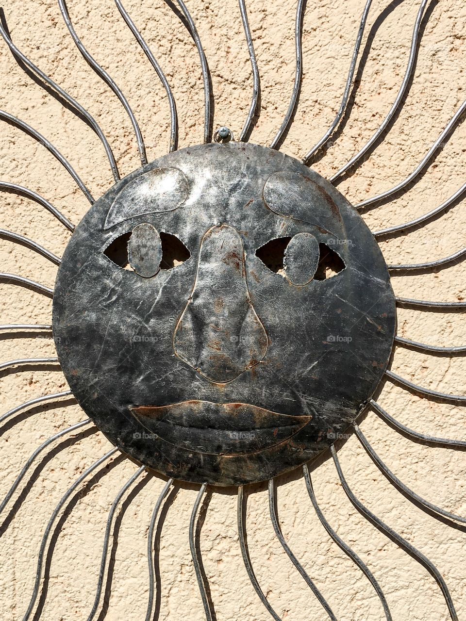 Metal sun with face 