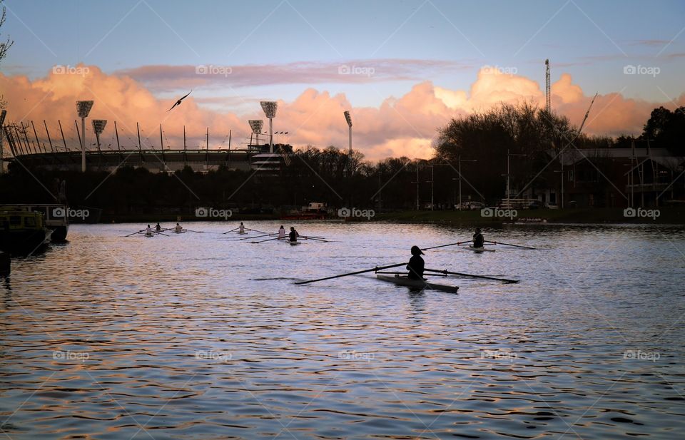 Rowing training in sunset 