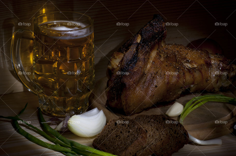 Roasted pork leg (rulka). roasted pork leg (rulka) served with mug of beer, onion, rye bread