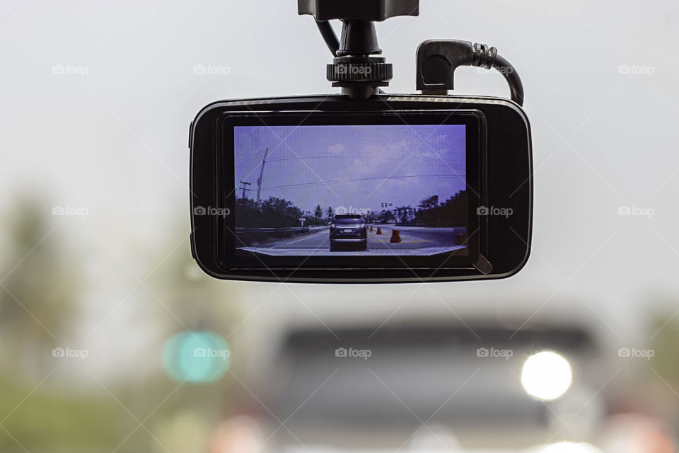 Picture cars and sky on camera in car.