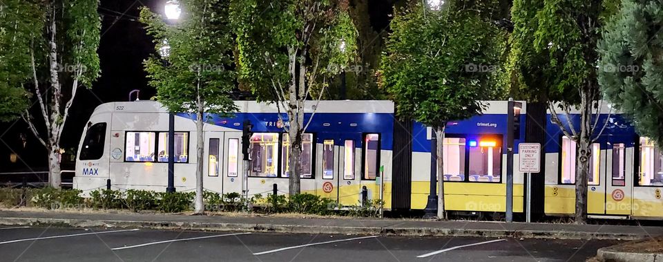 Tri Met Maxline public commuter train at night in Oregon as seen from the nearby parking lot