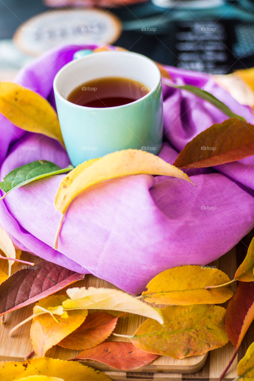 Hot flower tea in a blue mug on a wooden background
