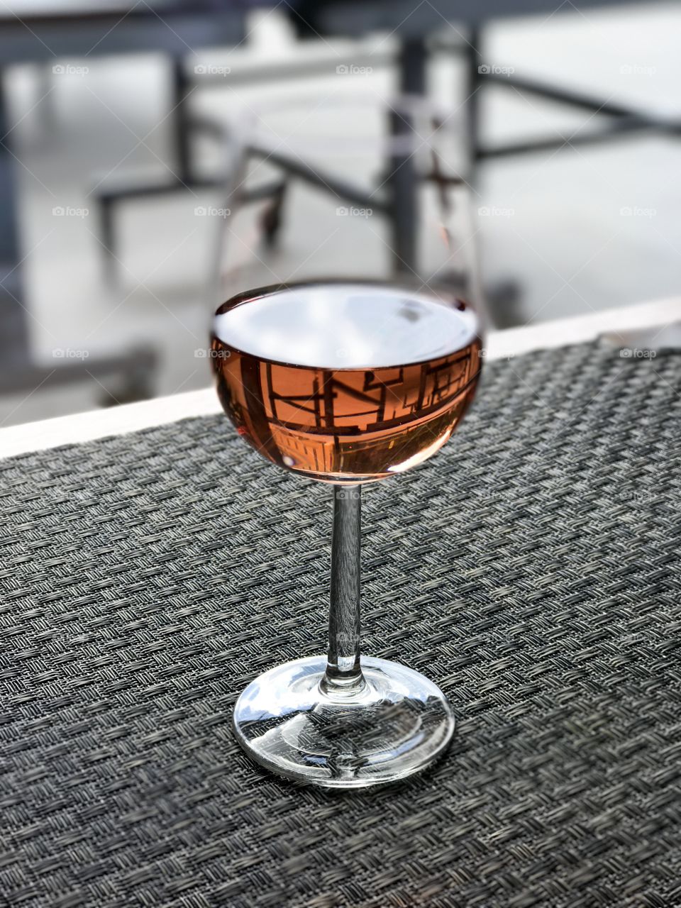 Glass of rose wine on a wooden table.