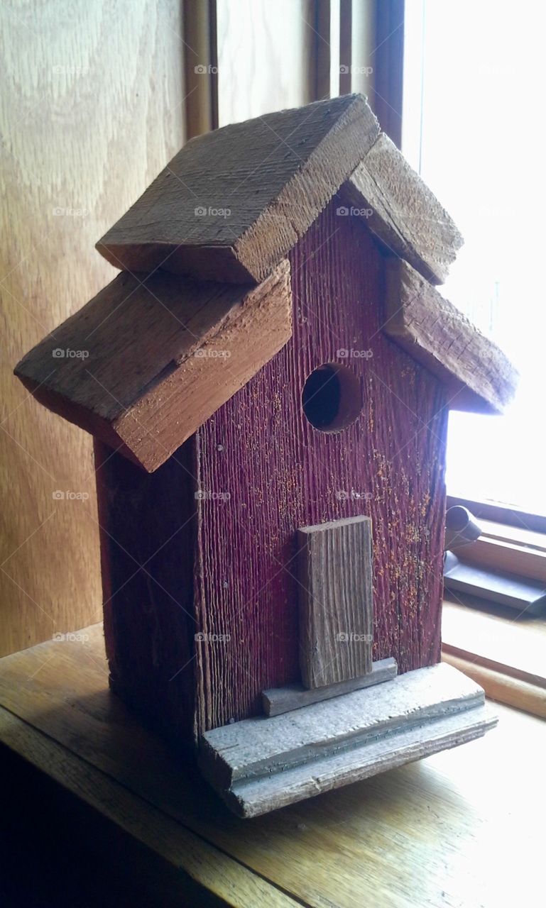A rustic red barn wood bird house. Has sentimental character because I built it  from my barn that had collapsed.