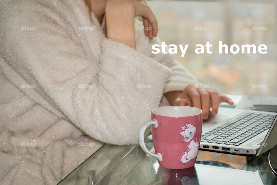 Stay home text. Isolation in home to prevent coronavirus. Girl having coffee and working at home