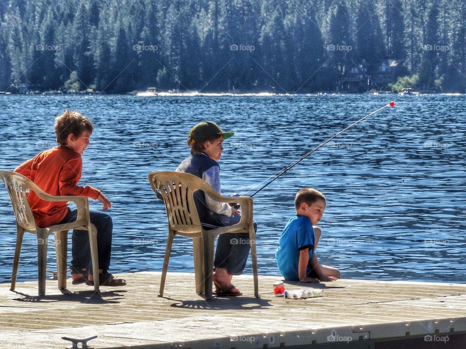 Young Boys Fishing On A Lake