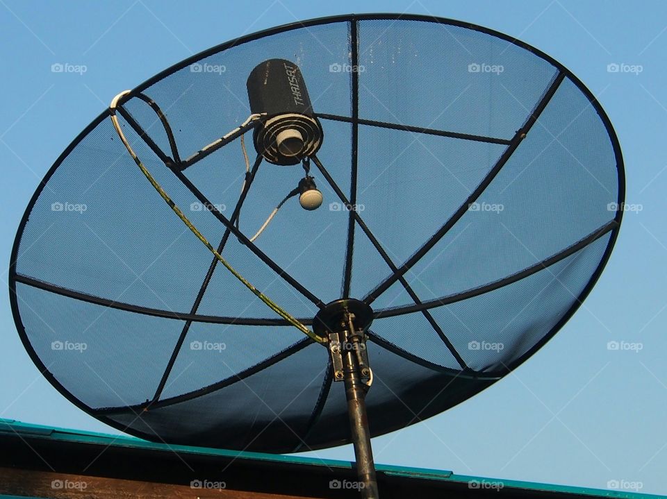 Satellite dish in blue sky background