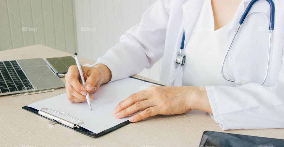 Doctor​ is writing​ prescription