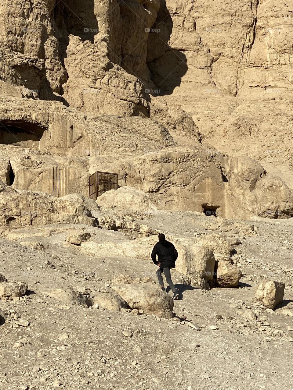 A young man is climbing up a mountain 