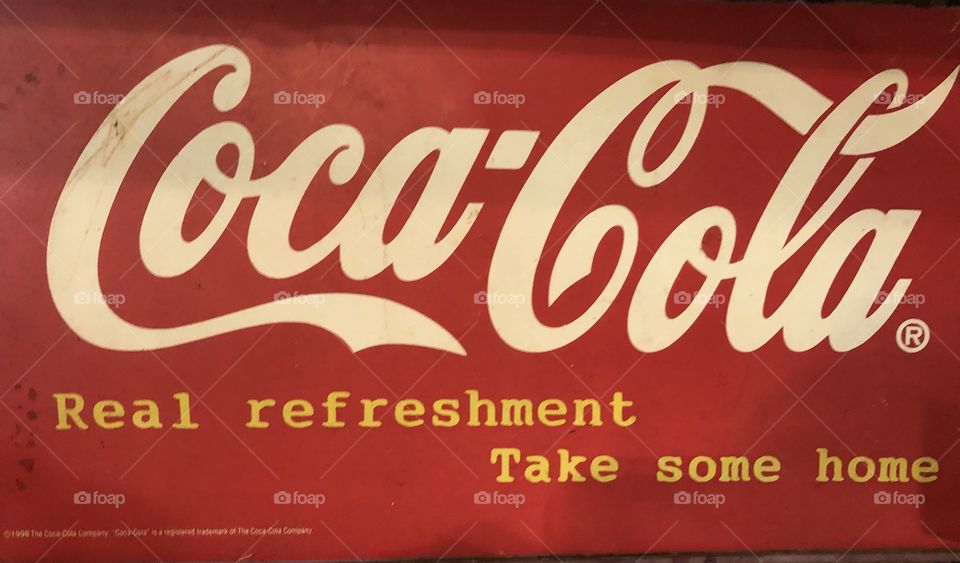 A tin vintage red and , white, tCoca Cola sign. 