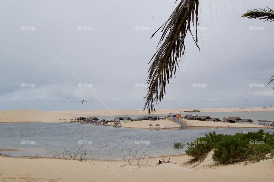 Desert White sand and lake water rain . little house wood made . 
