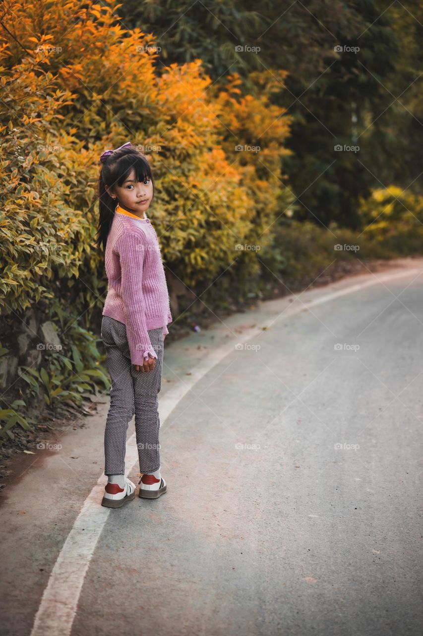 A little girl looking back at the camera and striking a pose...