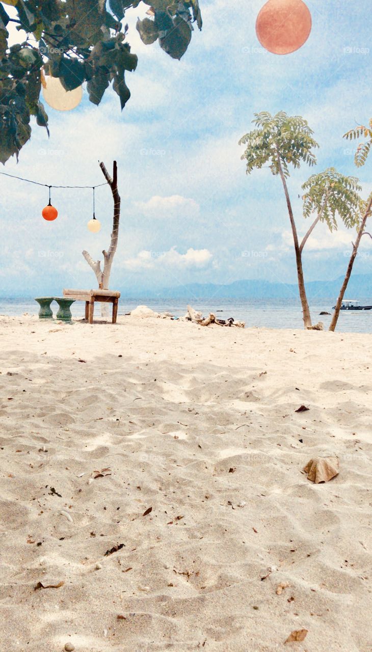 Sandy beach with chair and table