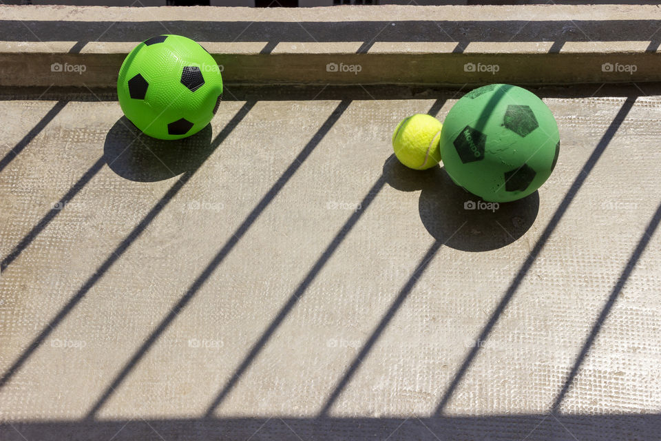 Fence shadow over balls