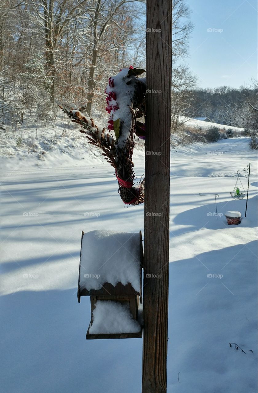 Snowy birdhouse and wreath